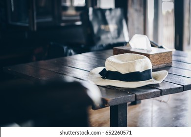 A hat on a table,vacation time.