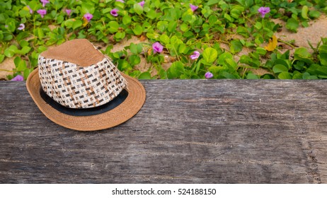 hat on the timber with grass background