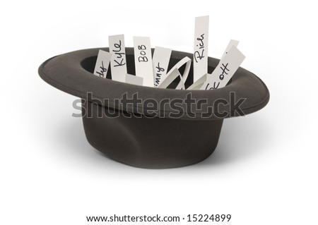 Hat on a white background filled with pieces of paper with names written on them