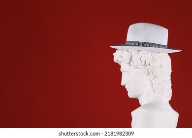 hat on white plaster head sculpture