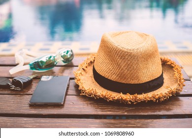 The Hat Is Placed At The Wooden Table Side The Swimming Pool With Smartphone And Goggle.Vintage Style