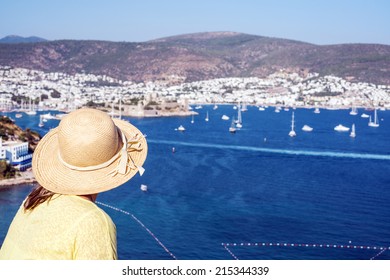 Hat Woman Is Looking To The Bodrum Castle And  Marina Of Bodrum ,Turkey