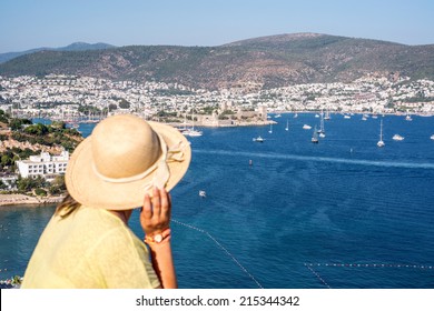 Hat Woman Is Looking To The Bodrum Castle And  Marina Of Bodrum ,Turkey