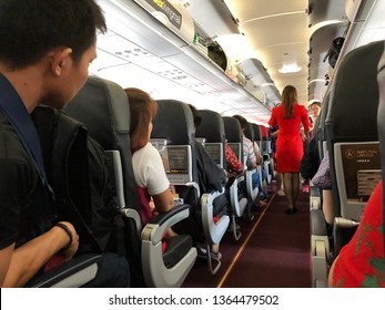 Hat Yai,Thailand - 18-03-2019 : Air Asia’s Air Hostess Helping Customers To Store Bags In The Flight When Heading To Chiang Mai From Hat Yai International Airport.