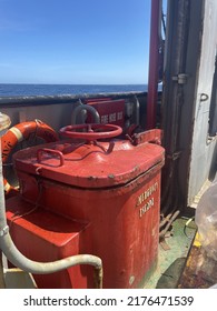 Hatch Cover Of The Emergency Escape Door On The Ship With Red Color And The Words 