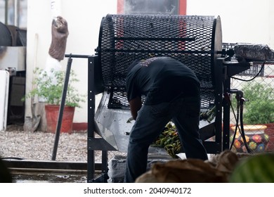 HATCH, NEW MEXICO - SEPTEMBER 4, 2021: A Worker Roasting Green Chiles During The Annual Hatch Chile Festival.