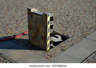 hatch for storing drawers and water inlets for watering and placement of market stalls in the square. the collector is hidden under the paving and laid with same paving