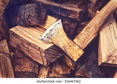 Hatchet Ax And Pile Of Split Wood Logs For Fire, Selective Focus With Shallow Depth Of Field, Toned Image.