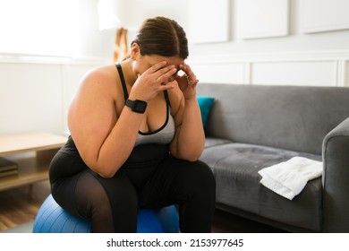 I hate exercising. Tired and sad fat woman feeling exhausted after a strong cardio workout and pilates at home - Shutterstock ID 2153977645