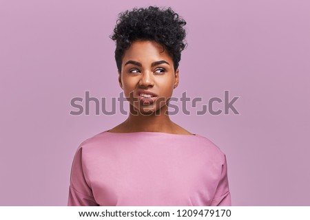 I hate you! Depressed stressful African American female clenched teeth, feels anger because of much work and duties about house, fed up with everything, has quarrel with enemy, poses indoor