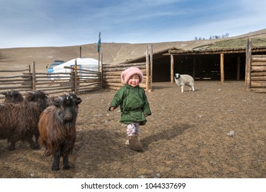 Hatgal, Mongolia, 3rd March 2018: Mongolian Kid With Goats Near His Home Ger (yurt) In A Steppe Of Northern Mongolia