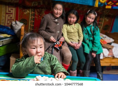 Hatgal, Mongolia, 3rd March 2018: Mongolian Kid In His Home Ger (yurt) With His Sisters At The Background