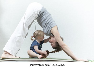 Hatha yoga fitness mother with baby