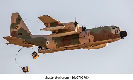 Hatzerim, Israel - December 23, 2019: C-130 demonstrating a Equipment parachute over the battlefield in flight course 179 ceremony