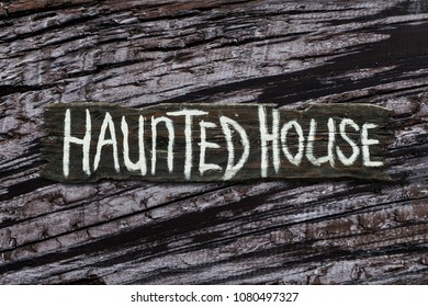 Haunted House Sign On Gray Dried Wood Texture Background