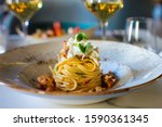 haute cuisine dish with spaghetti with lobster, buffalo stracciatella and a fine white wine. In a luxurious Italian restaurant