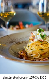 haute cuisine dish with spaghetti with lobster, buffalo stracciatella and a fine white wine. In a luxurious Italian restaurant - Shutterstock ID 1590361333