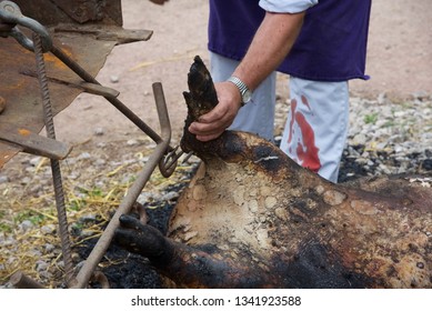 Hauts-de-France/France-June 25 2018: Pig slaughter-moments after death the preparation of the carcass by removing hair, pressure washing, evisceration, and cutting the carcass in two - Shutterstock ID 1341923588