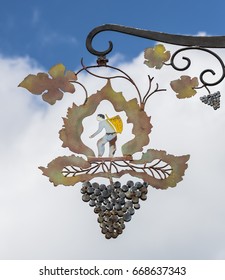 Hautvillers, France - June 9, 2017: Ornament Of A Man Picking Grapes With Basket In The Vinyard, Hanging On The Wall In Hautvillers In The Champagne District In France.