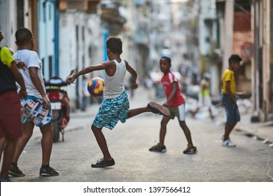 Havana, Cuba 02.05.2019 Group Of Kids Are Playing Soccer In The Middle Of The Street 