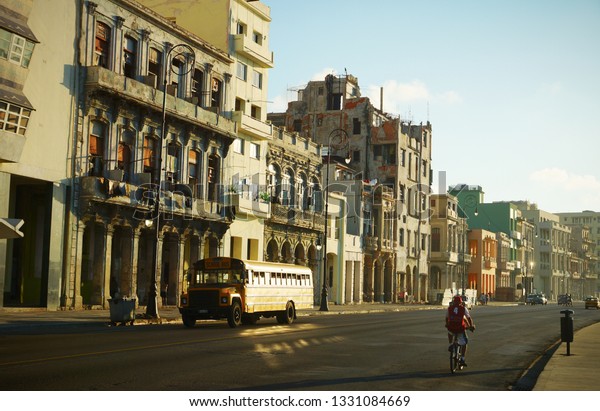 Havana, Cuba.\
02/10/2014 Historic houses on the Malecon seafront in Havana. Old\
school bus in Havana. Editorial.\
