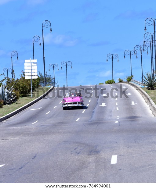 HAVANA - CUBA /\
02.26.2107: An old pink American car driving along the Malecon (sea\
front) in Havana, Cuba