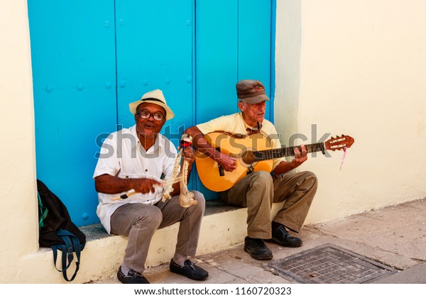 Havana, Cuba - 2018 \
Two local street\
entertainers playing cuban music in Havana,\
Cuba.