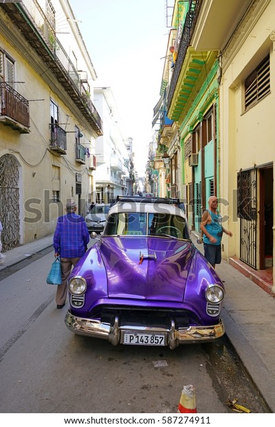 HAVANA, CUBA -3 FEB 2017- A purple vintage classic\
American car serving as a taxi in the old center of Havana, the\
capital of Cuba.