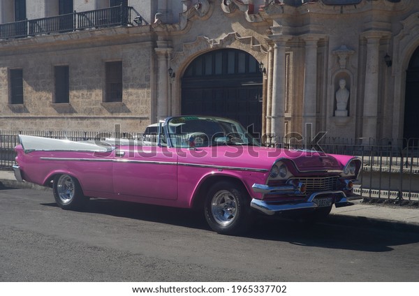  Havana Cuba 9-19-2018 Pink car parked in front of\
building        