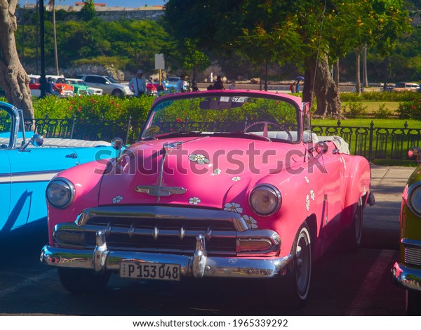  Havana Cuba 9-19-2018 Pink car parked in front of park \
      
