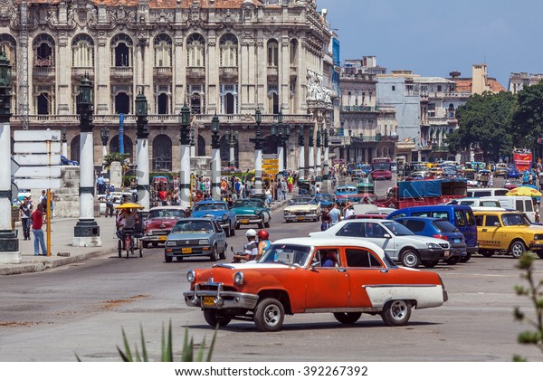 HAVANA, CUBA - APRIL 1, 2012:\
Heavy traffic with taxi bikes and vintage cars in front of\
Capitolio