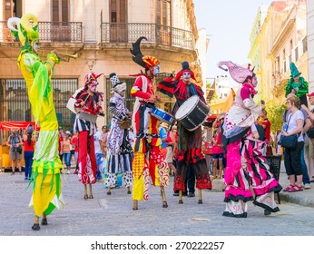 HAVANA, CUBA - APRIL 15,2015 : Colorful stiltwalkers dancing to the sound of cuban music in Old Havana