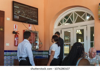 Havana / Cuba - April 18, 2018: Cubans Watch Cuban TV On A Rooftop Bar In Havana As Raul Castro Cedes Power To Miguel Díaz-Canel.