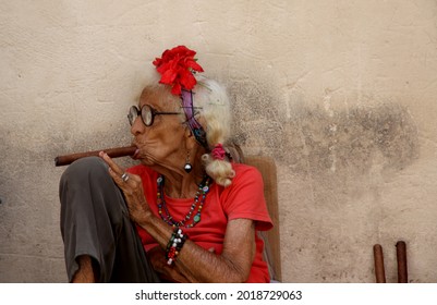 Havana Cuba April 2013. An elderly lady smokes a Cuban cigar and poses