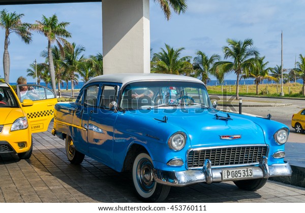 HAVANA,\
CUBA - APRIL 7, 2016: Old classic American cars rides in city\
streets. Before a new law issued on October 2011, cubans could only\
trade cars that were on the road before\
1959.