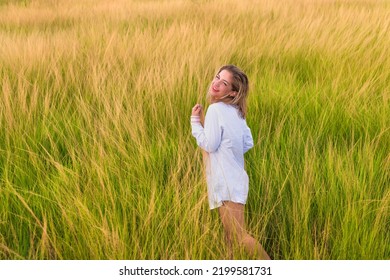 Havana, Cuba. August 1, 2020. Young Woman On Field Of Tall Grass During Sunset