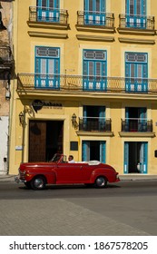 Havana, Cuba - August 27 2018: A Red Classic Car Drives Along Carlos Manuel Céspedes Avenue In Old Havana.