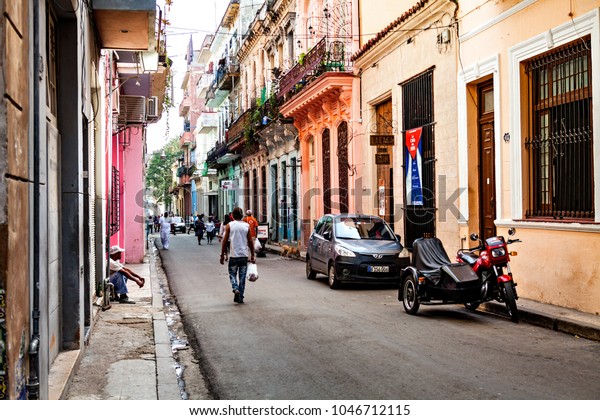 Havana, Cuba -\
December 12, 2016: Local people in the streets of Old Havana/Cuba\
with its colourful\
houses.