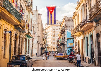 Havana, Cuba in December 2015: A cuban flag with holes waves over a street in Central Havana. La Habana, as the locals call it, is the capital city of Cuba