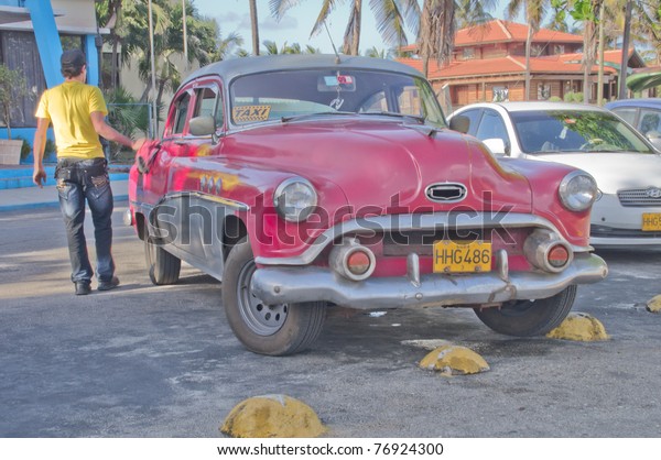 HAVANA, CUBA - FEB 15: Vintage/Classic American\
Cars in use on February 15, 2011 in Havana, Cuba.  Cubans have held\
on to vintage automobiles for many decades due to limited access to\
new cars.