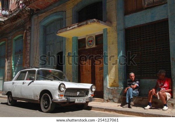 HAVANA, CUBA, FEBRUARY 15, 2014 : Classic old\
American car in the streets of Havana. Classic cars are still in\
use in Cuba and old timers have become an iconic view and a\
worldwide known\
attraction.
