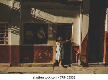 Havana, Cuba - February 23, 2017: The Old Lady At The Door Of His House. Behind Her - 