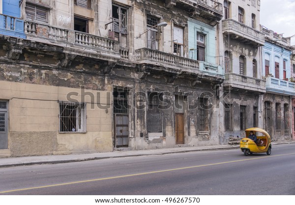 HAVANA, CUBA - JANUARY 15, 2016: Old buildings and\
coco taxi