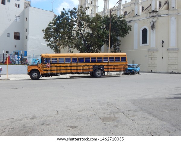      Havana, Cuba.\
January 2015. School Bus and old Russian car  in Havana.           \
              