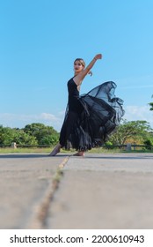 Havana, Cuba. January 7, 2021. Young Dancer Waving Her Black Dress In The Middle Of The Road