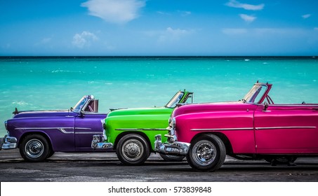 Havana, Cuba - July 05, 2015: HDR - Three colorfully Chevrolet Cabriolet classic cars parked before the Caribbean Sea on the Malecon in Havana Cuba  - Serie Cuba Reportage