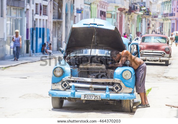 HAVANA, CUBA - JULY 18 : Old classic\
American cars on one of Havana\'s streets on July 18 2016. There is\
nearly 60,000 vintage American cars in Cuba\
