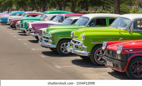 Havana, Cuba - July 23, 2018; A Row Of Typical Colorful Cuban Oldtimer Classic Cars Standing In Line During Day Time On A Parking Lot