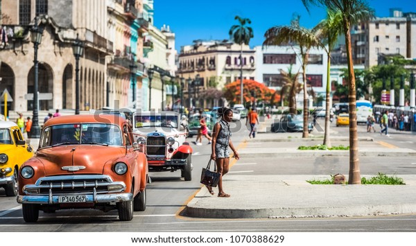 Havana, Cuba - June 27, 2017: HDR -\
Street life view on the main street with american brown Chevrolet\
classic car in Havana City Cuba - Serie Cuba\
Reportage