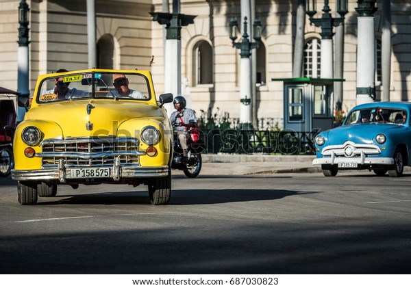 Havana, Cuba - June 27, 2017: American\
convertible yellow Dodge classic car on the crossroad in Havana\
Cuba- Serie Cuba\
Reportage
